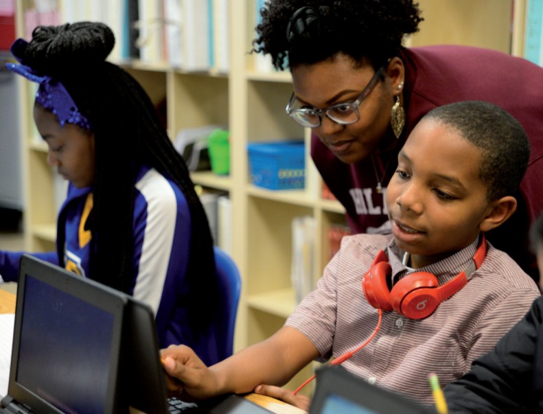 Student working with teacher